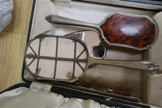 A cased plated and tortoiseshell brush set